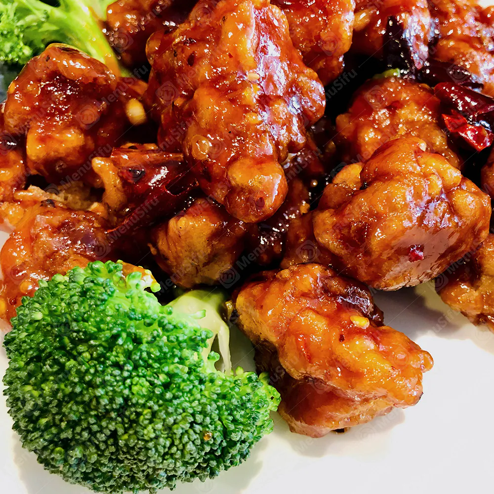 Crispy fried chicken coated in glossy sweet-sour sauce, served with broccoli at China Wok, a Chinese Restaurant in Marion